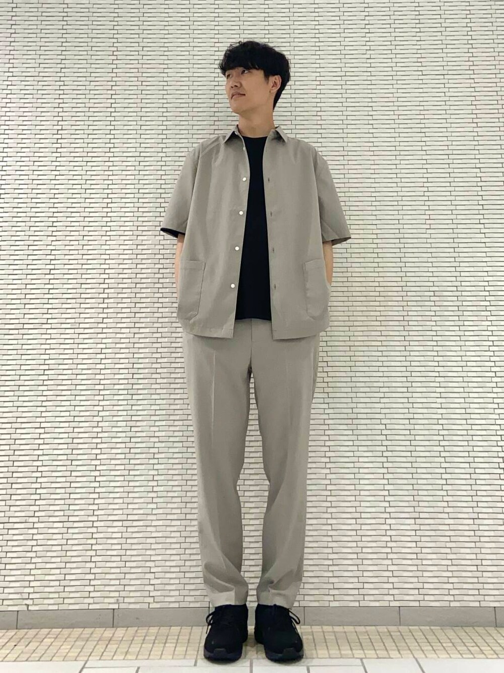 ベージュ系のその他パンツ、ブラック系のTシャツ/カットソー、ブラック系のスニーカーを着用したメンズの夏コーディネートの1枚目の写真