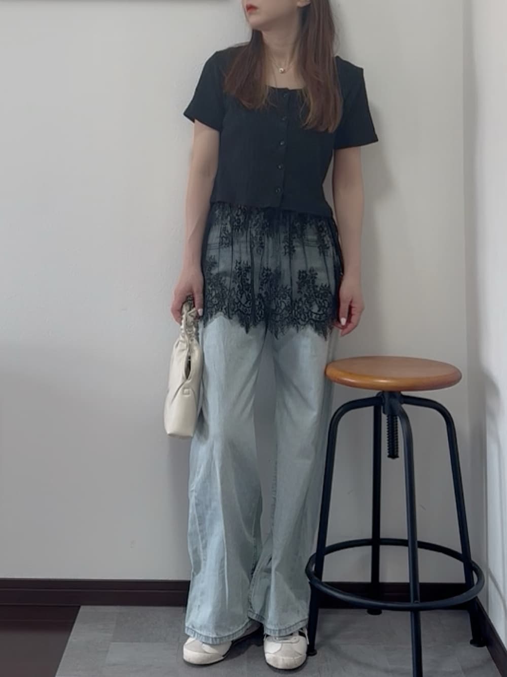 ブラック系のTシャツ/カットソー、ブルー系のデニムパンツを着用したレディースの春コーディネートの1枚目の写真