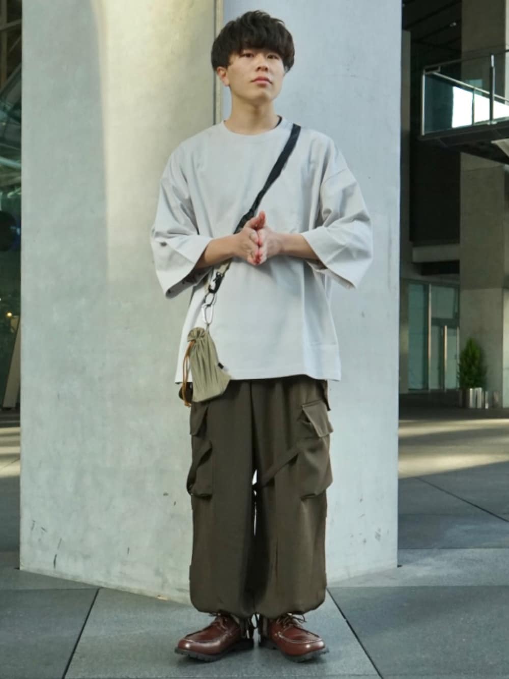グレー系のTシャツ/カットソー、グリーン系のサロペット/オーバーオール、ベージュ系のショルダーバッグを着用したメンズの冬コーディネートの1枚目の写真