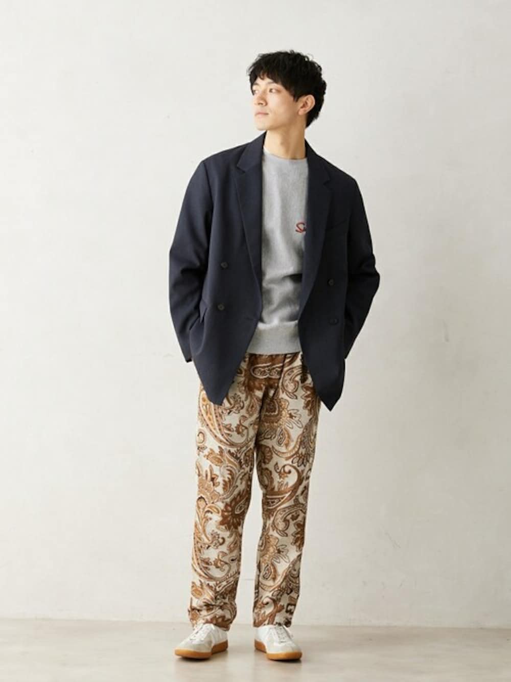 ホワイト系のスラックス、ホワイト系のスニーカーを着用したメンズの冬コーディネートの1枚目の写真