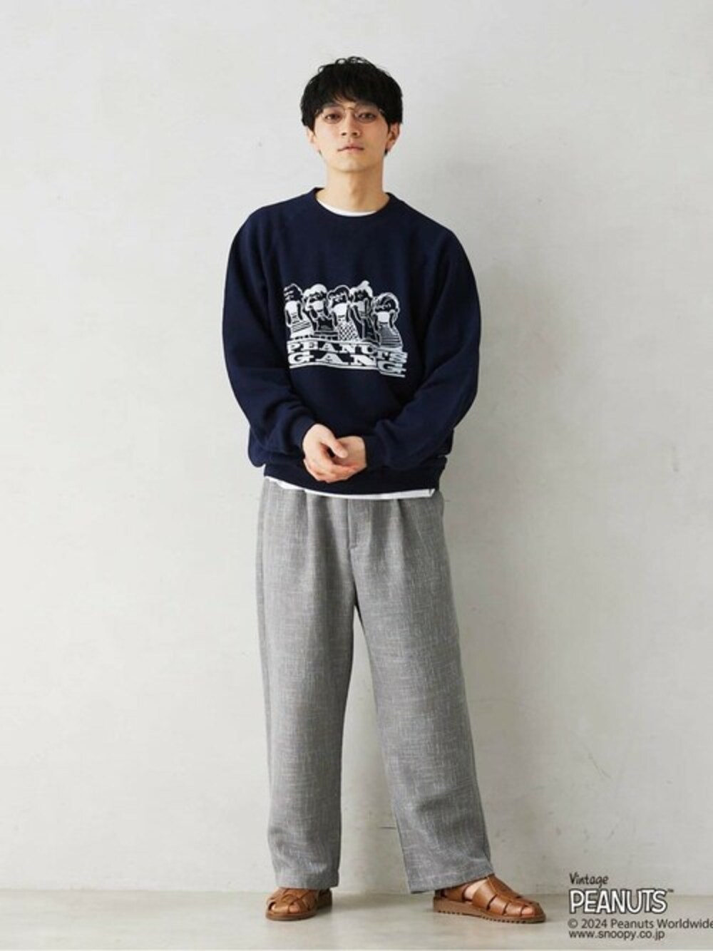 ブルー系のTシャツ/カットソー、グレー系のスラックスを着用したメンズの冬コーディネートの1枚目の写真