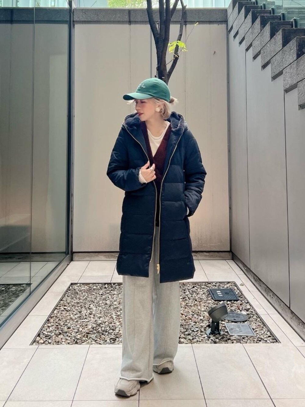 ブラック系のダウンジャケット/コート、ブラウン系のカーディガン/ボレロを着用したレディースの秋コーディネートの1枚目の写真