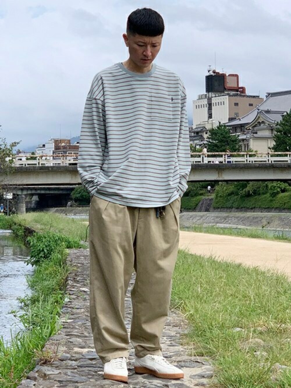 ホワイト系のスニーカーを着用したメンズの秋コーディネートの1枚目の写真