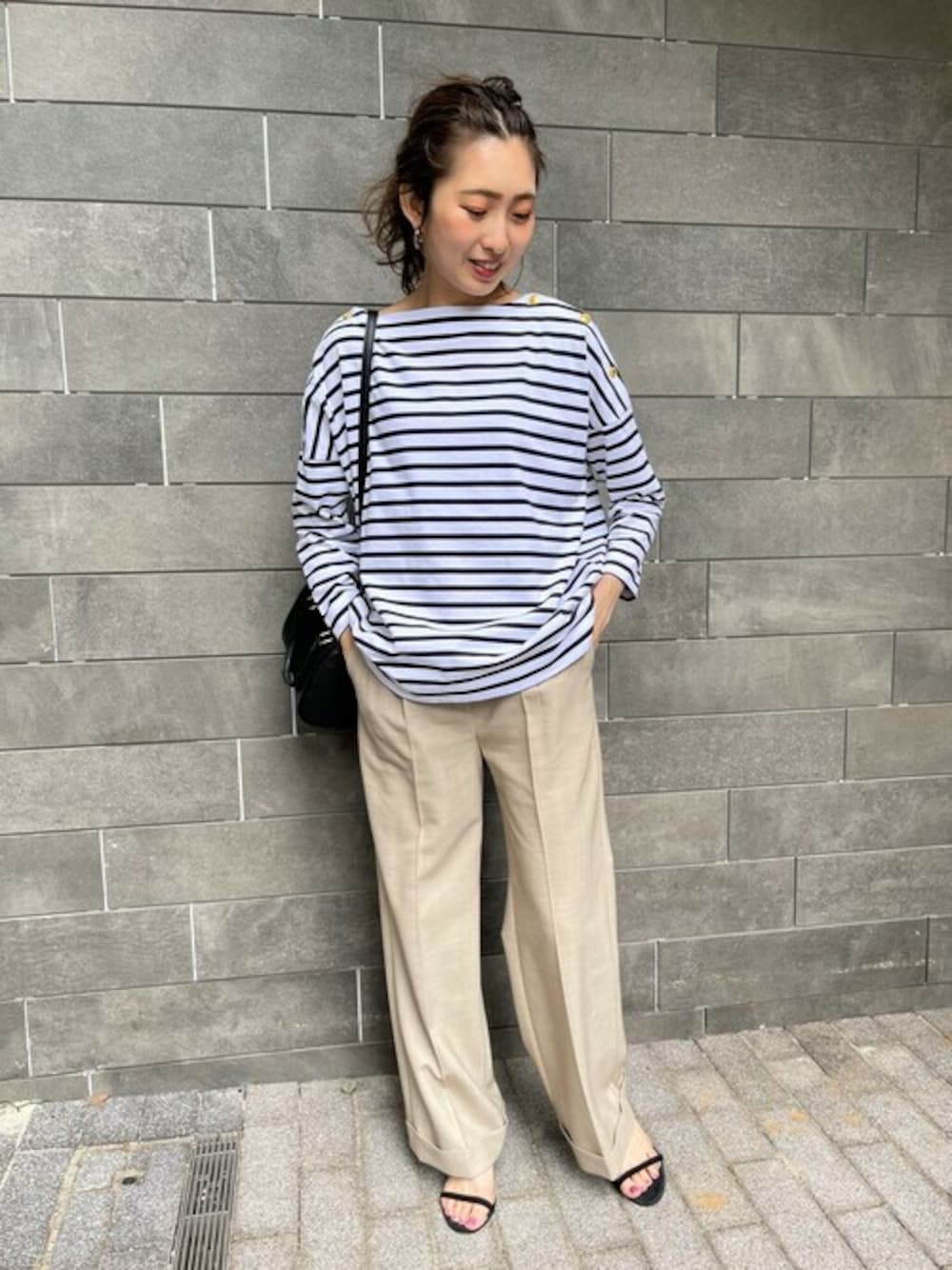 ホワイト系のTシャツ/カットソー、ベージュ系のスラックス、ブラック系のボストンバッグを着用したレディースの夏コーディネートの1枚目の写真