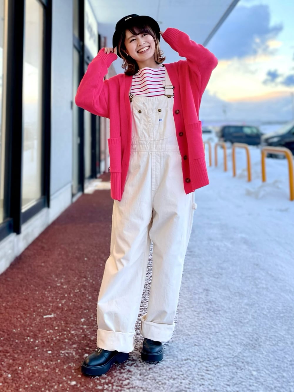 ホワイト系のサロペット/オーバーオール、ピンク系のカーディガン/ボレロ、ピンク系のTシャツ/カットソーを着用したレディースの冬コーディネートの1枚目の写真