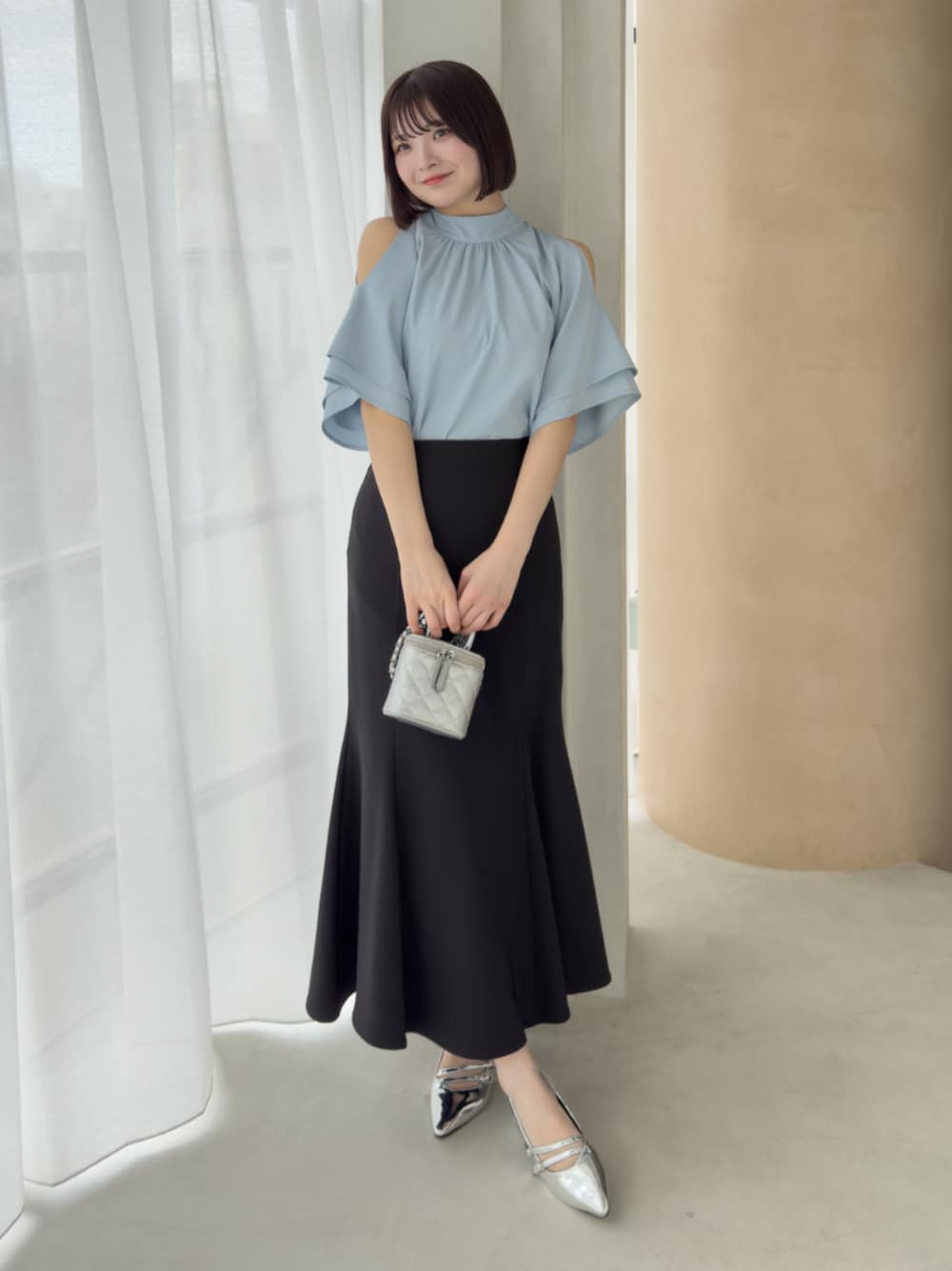 ブラック系のスカート、シルバー系のサンダル、グレー系のシャツ/ブラウスを着用したレディースの春コーディネートの1枚目の写真