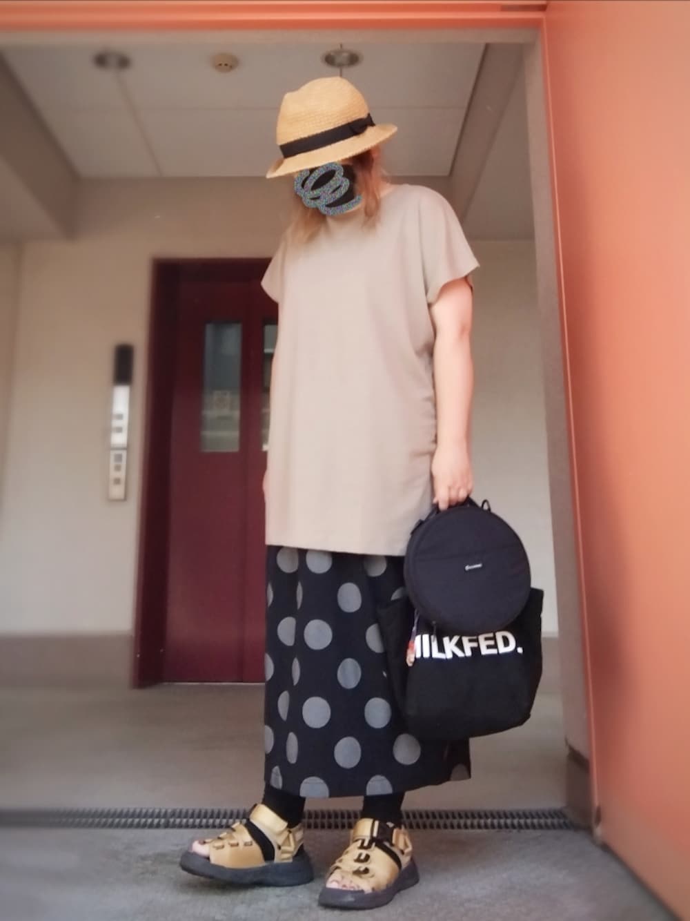 グリーン系のTシャツ/カットソー、ブラック系のトートバッグ、ブラック系のスカートを着用したレディースの夏コーディネートの1枚目の写真