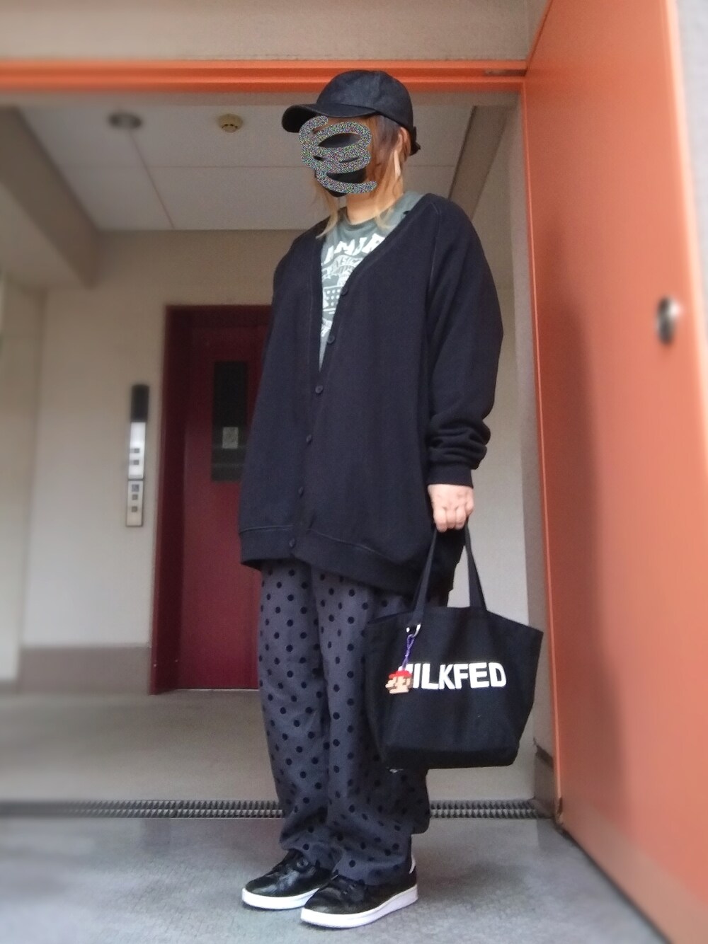 グリーン系のTシャツ/カットソー、ブラック系のカーディガン/ボレロ、ブラック系のトートバッグを着用したレディースの秋コーディネートの1枚目の写真
