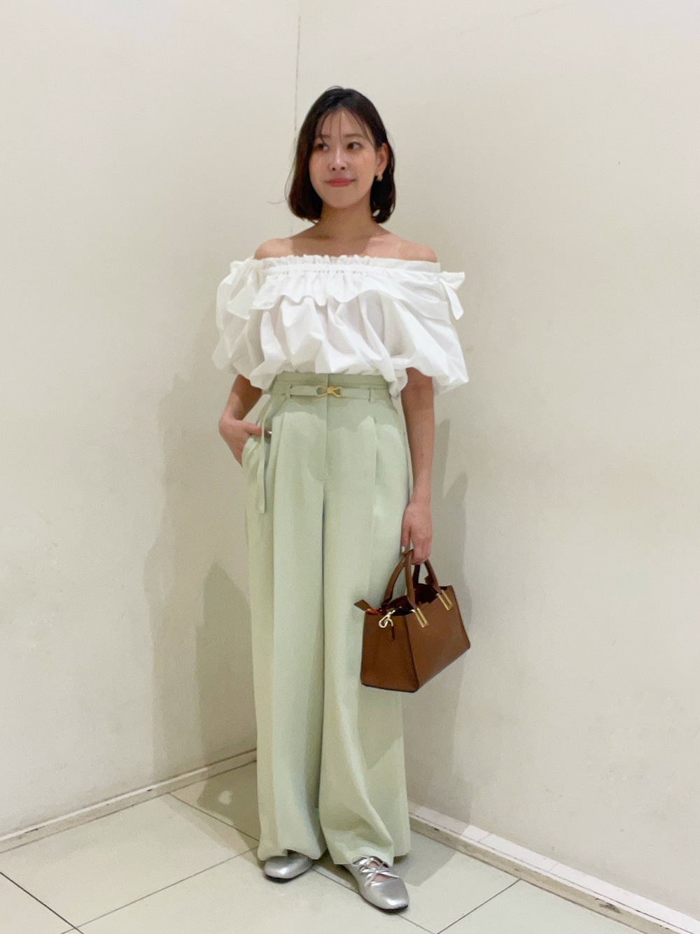グリーン系のその他パンツ、ホワイト系のシャツ/ブラウス、ブラウン系のトートバッグを着用したレディースの夏コーディネートの1枚目の写真