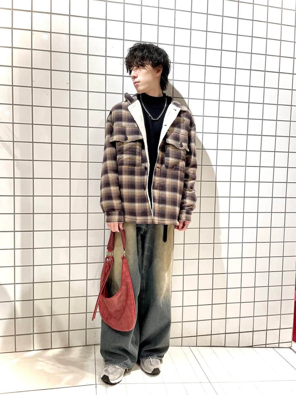 ブラック系のニット/セーター、ブルー系のデニムパンツ、ブラウン系のその他アウターを着用したメンズの冬コーディネートの1枚目の写真