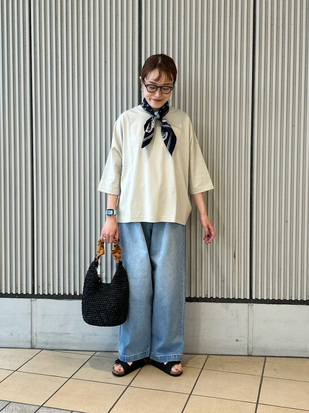 ブルー系のデニムパンツ、グレー系のTシャツ/カットソー、ブラック系のサンダルを着用したレディースの夏コーディネートの1枚目の写真