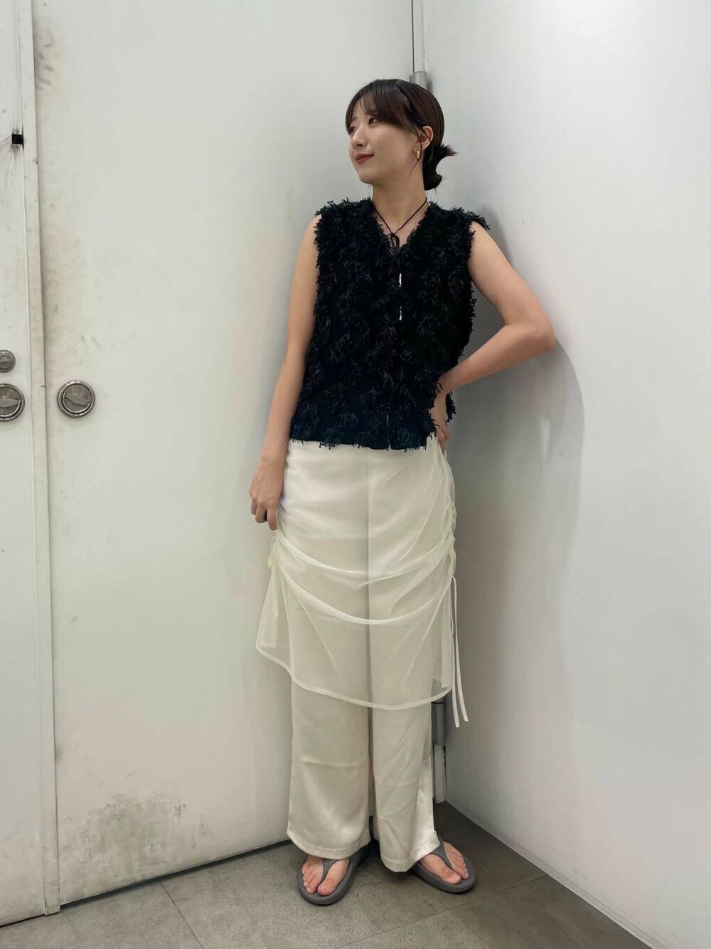 ホワイト系のその他パンツ、ブラック系のベストを着用したレディースの秋コーディネートの1枚目の写真