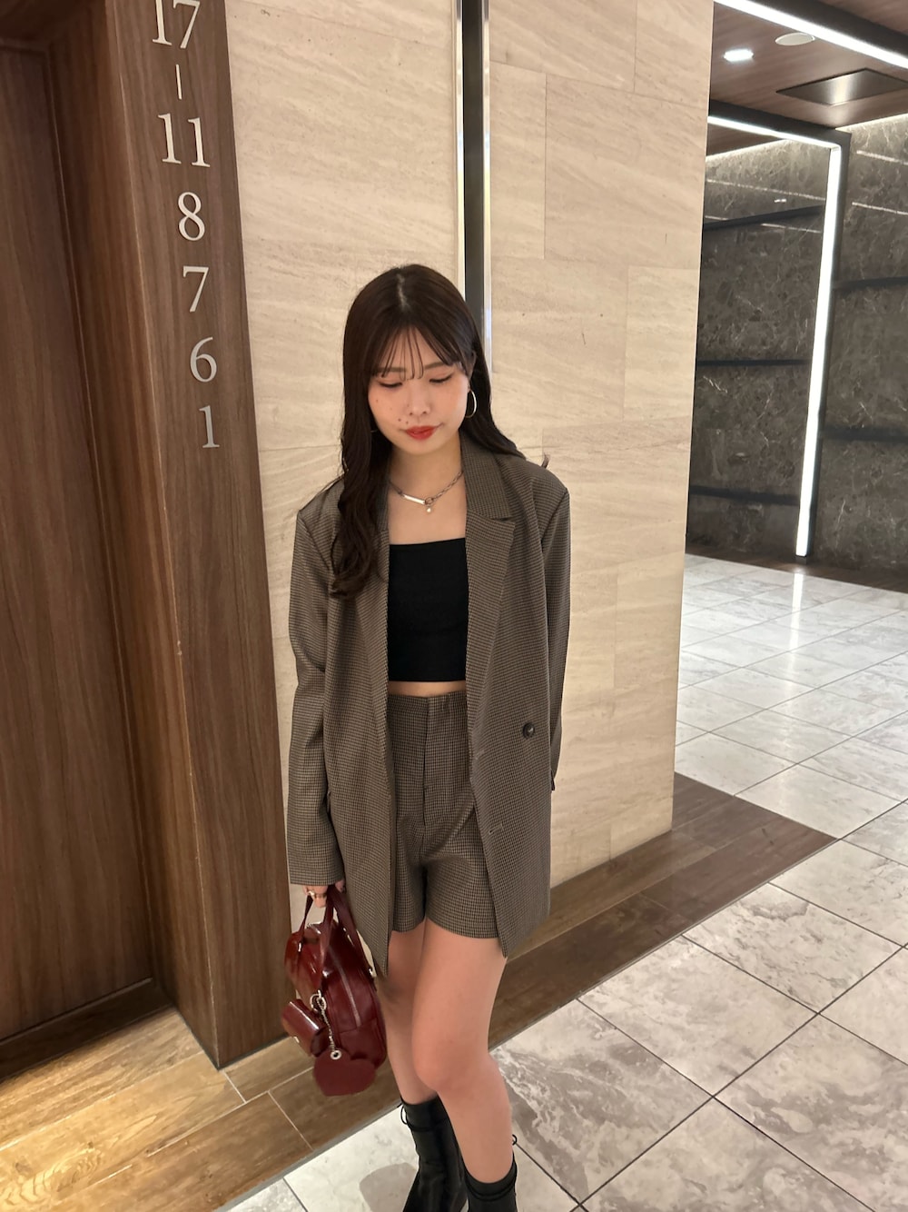 ブラウン系のテーラードジャケット、ブラウン系のその他パンツ、レッド系のボストンバッグを着用したレディースの夏コーディネートの1枚目の写真