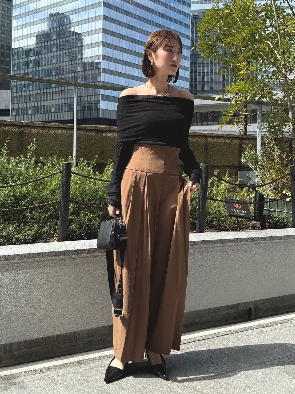 ブラック系のTシャツ/カットソー、ブラック系のサンダル、ブラウン系のその他パンツを着用したレディースの春コーディネートの1枚目の写真