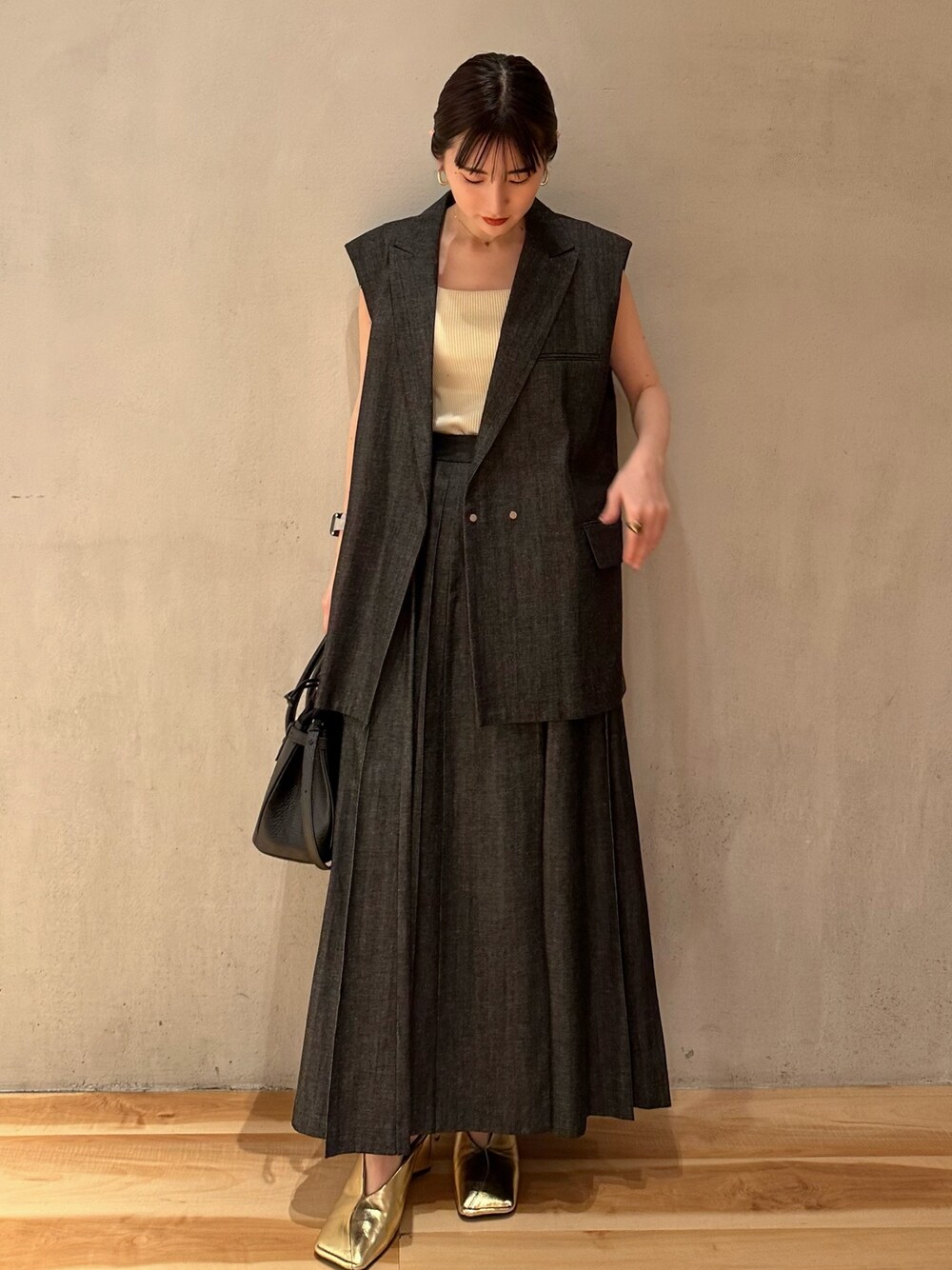 ゴールド系のパンプス、イエロー系のタンクトップ、その他のテーラードジャケットを着用したレディースの春コーディネートの1枚目の写真