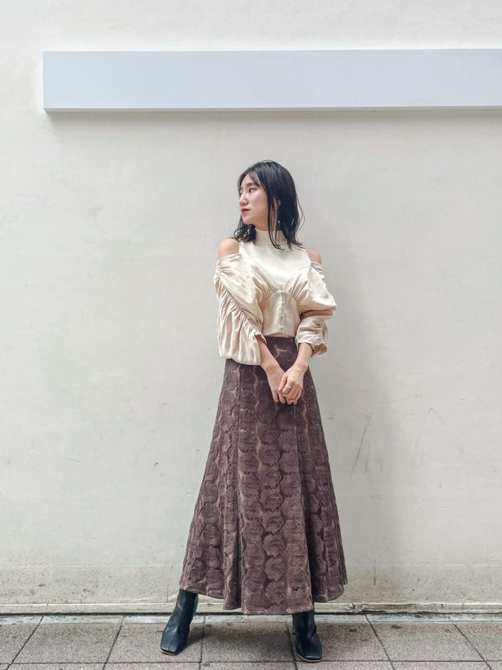 ブラック系のその他シューズ、ブラウン系のスカート、ホワイト系のニット/セーターを着用したレディースの秋コーディネートの1枚目の写真