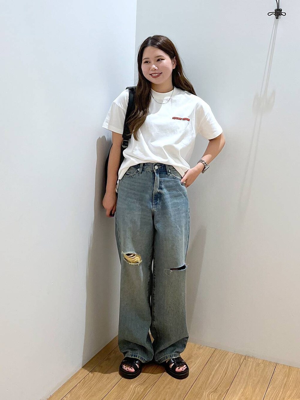 ホワイト系のTシャツ/カットソー、ブラック系のショルダーバッグ、ブラック系のスニーカーを着用したレディースの夏コーディネートの1枚目の写真