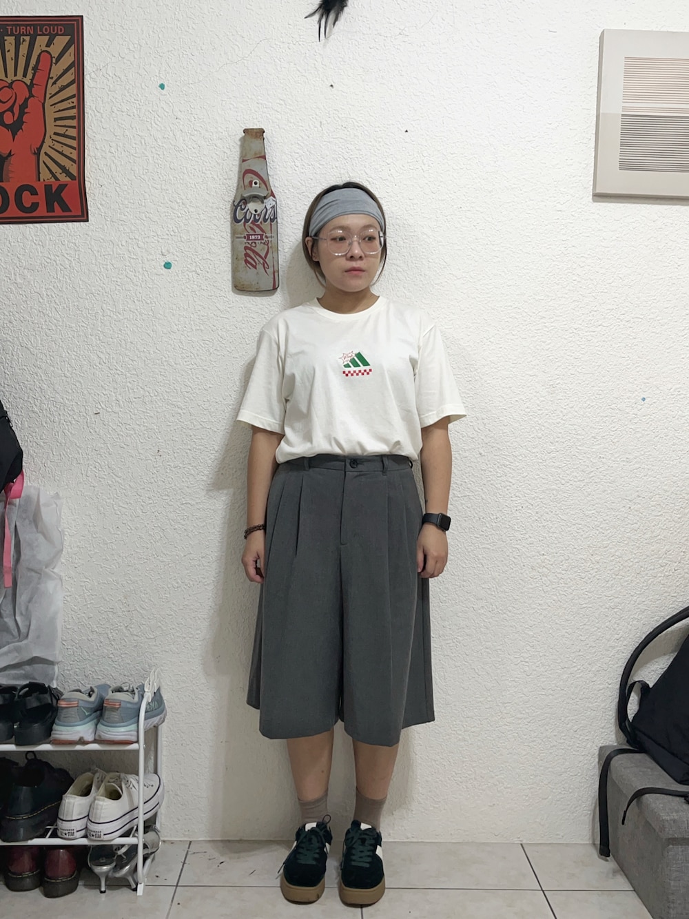 グリーン系のスニーカー、ホワイト系のTシャツ/カットソー、グレー系のスラックスを着用したレディースの秋コーディネートの1枚目の写真