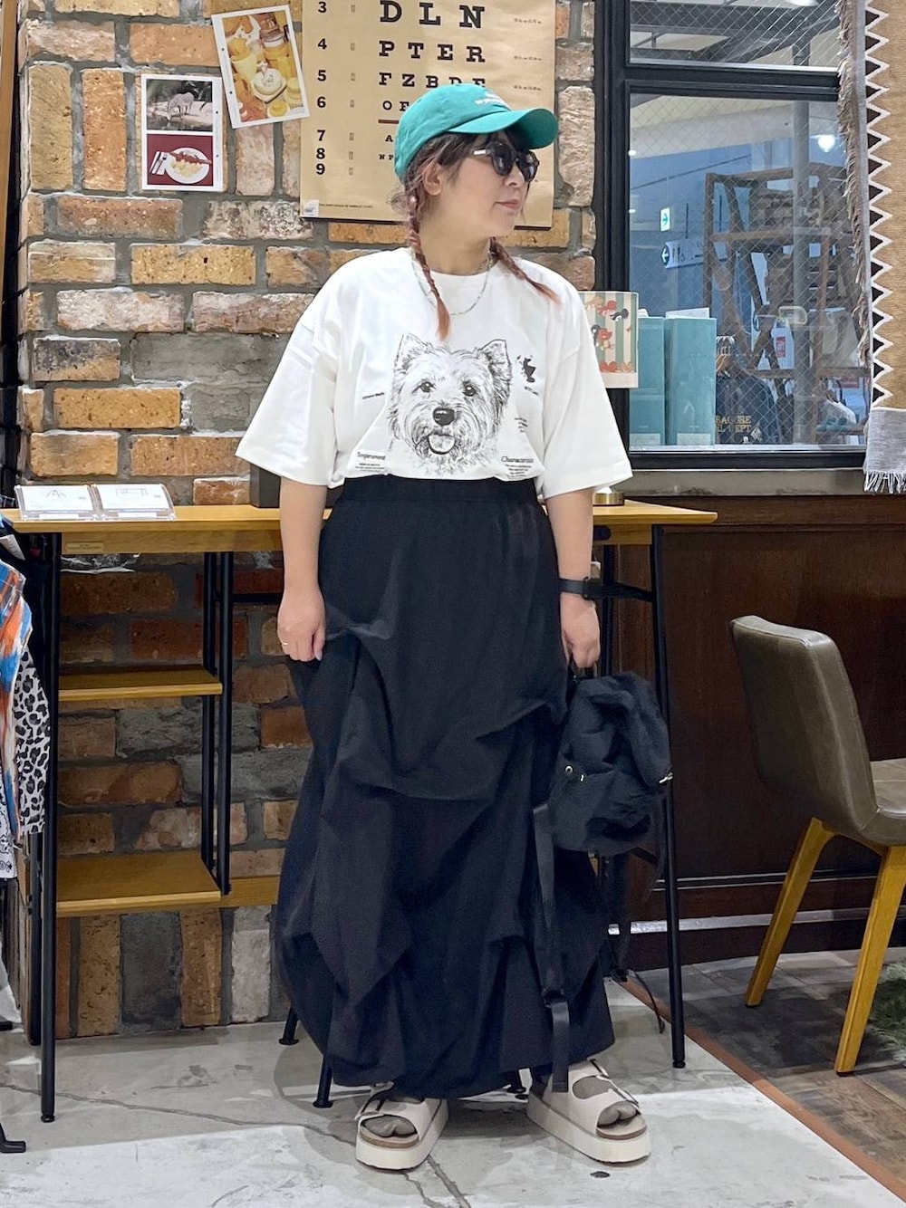 ベージュ系のサンダル、ホワイト系のTシャツ/カットソー、ブラック系のバックパック/リュックを着用したレディースの夏コーディネートの1枚目の写真