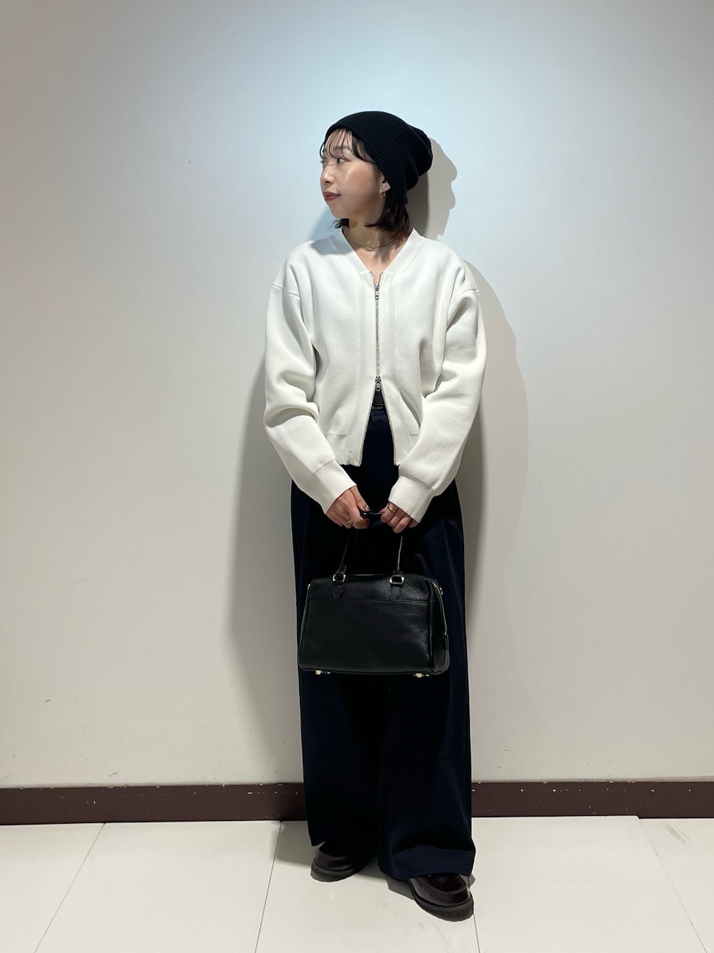 ブルー系のその他パンツ、ホワイト系のカーディガン/ボレロ、ブラック系のボストンバッグを着用したレディースの春コーディネートの1枚目の写真