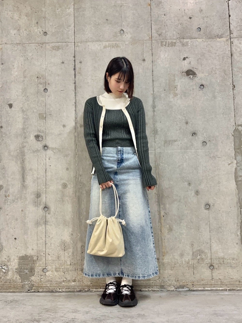 ブルー系のスカート、ホワイト系のニット/セーター、グレー系のニット/セーターを着用したレディースの冬コーディネートの1枚目の写真