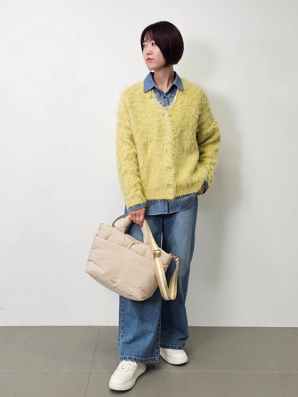 ブルー系のデニムパンツ、ブルー系のシャツ/ブラウス、イエロー系のカーディガン/ボレロを着用したレディースの秋コーディネートの1枚目の写真