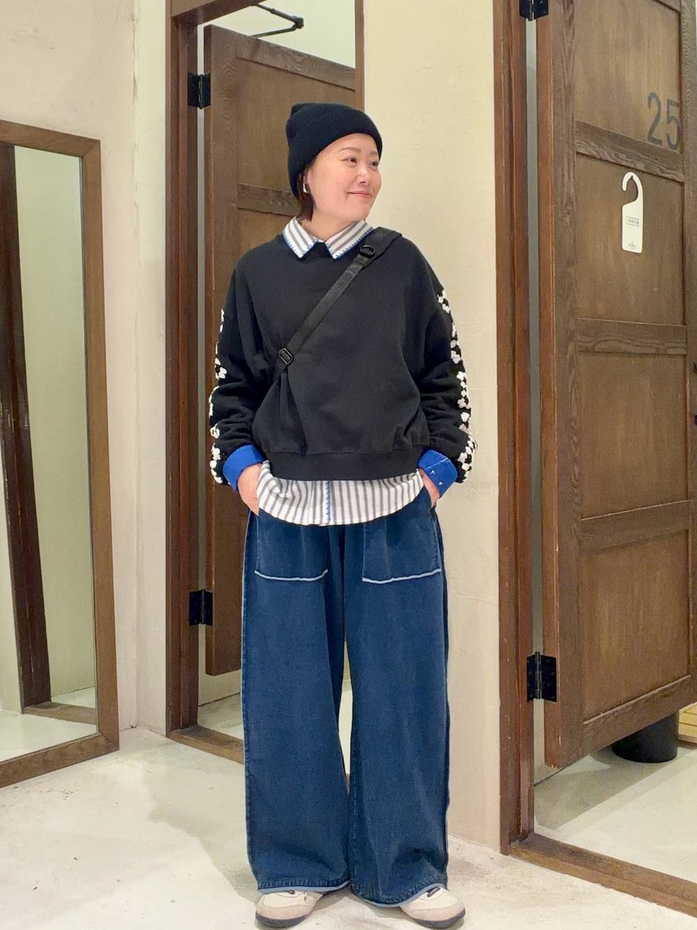 ブラック系のスウェット、ブラック系のショルダーバッグを着用したレディースの冬コーディネートの1枚目の写真