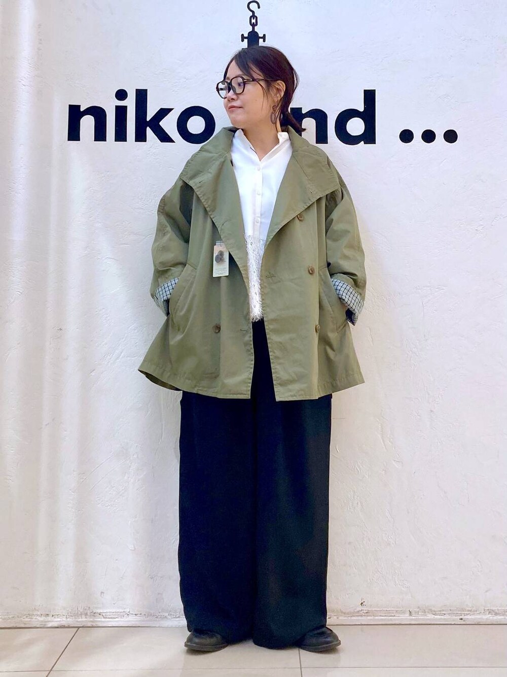 ブラック系のその他パンツ、グリーン系のトレンチコート、ホワイト系のシャツ/ブラウスを着用したレディースの冬コーディネートの1枚目の写真