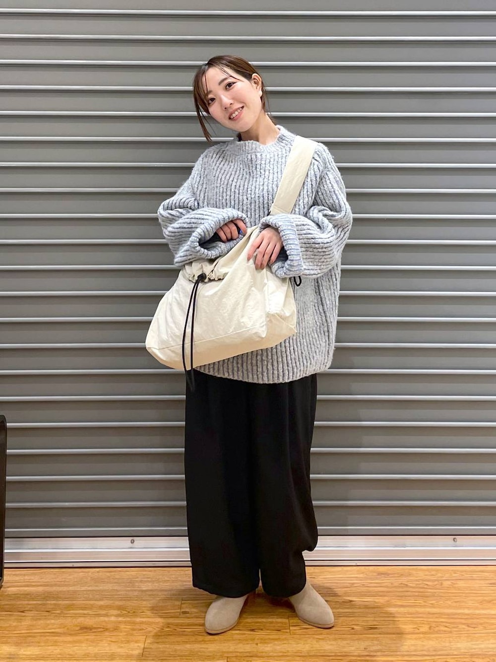 ベージュ系のブーツ、グレー系のニット/セーター、ブラック系のその他パンツを着用したレディースの秋コーディネートの1枚目の写真