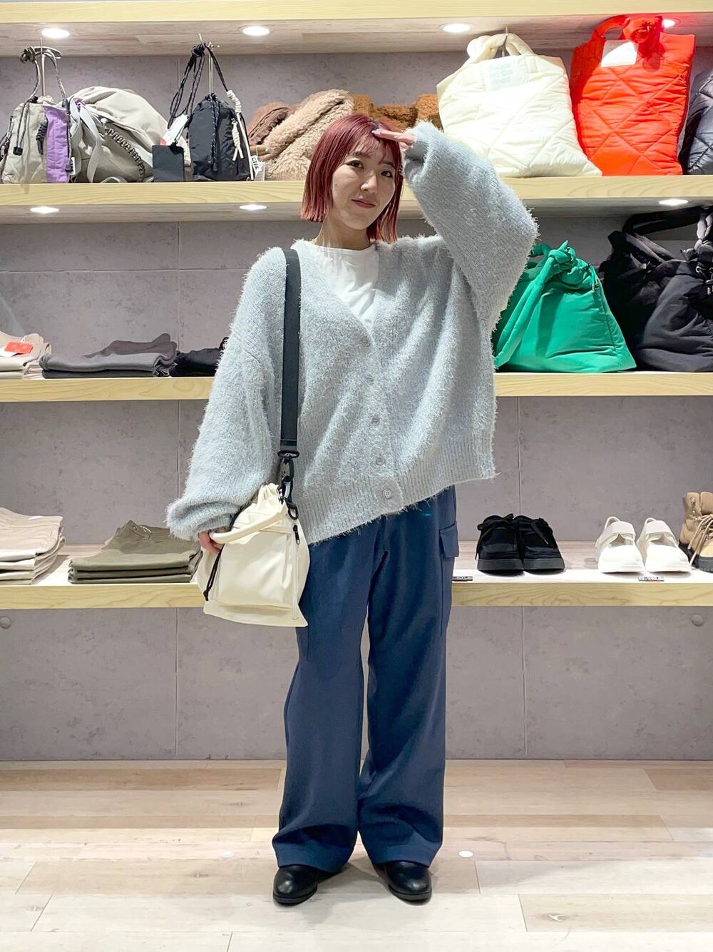 ホワイト系のTシャツ/カットソー、ブラック系のブーツ、グレー系のニット/セーターを着用したレディースの冬コーディネートの1枚目の写真