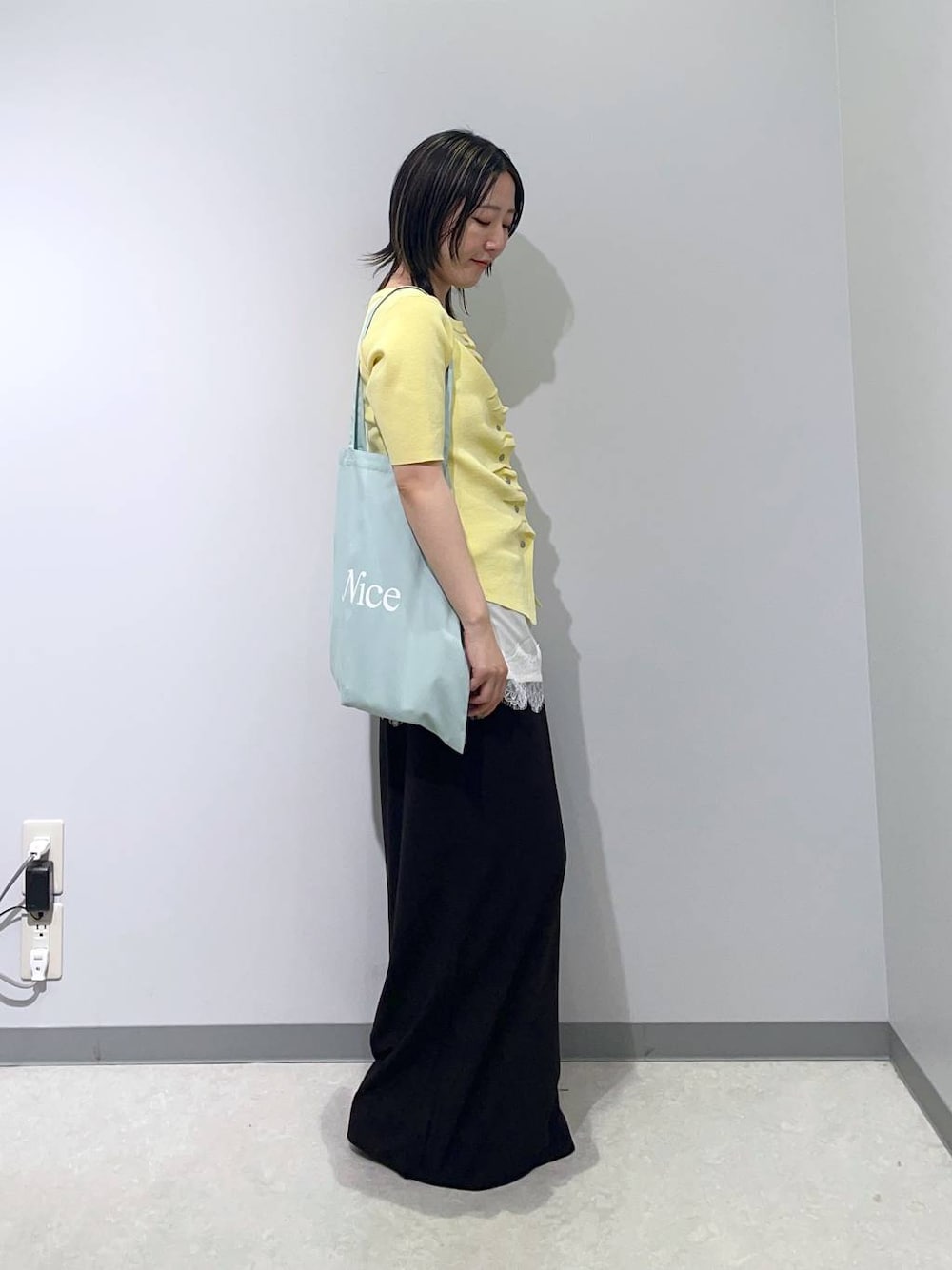 ブラック系のその他パンツ、ホワイト系のキャミソール、イエロー系のカーディガン/ボレロを着用したレディースの春コーディネートの1枚目の写真