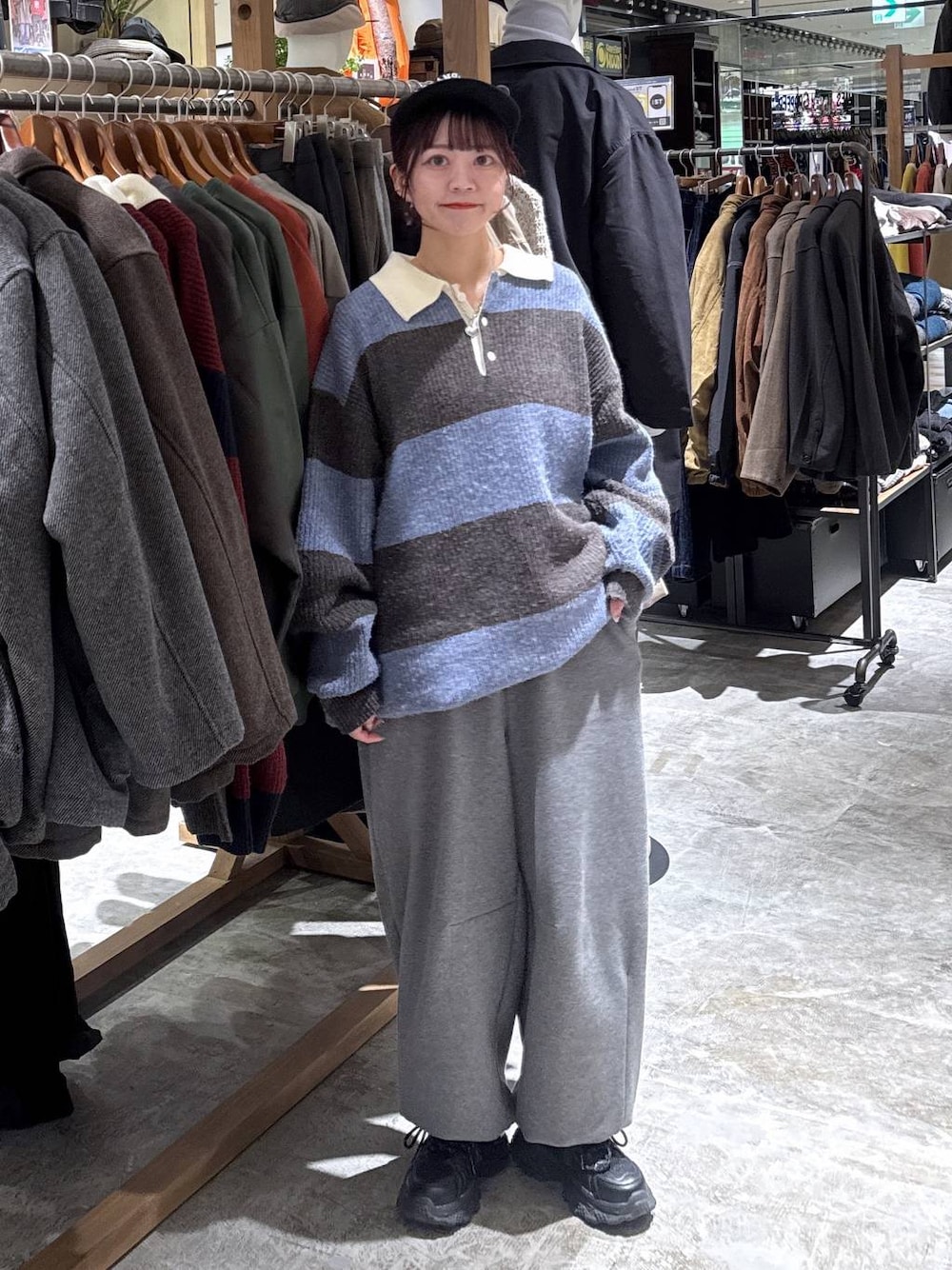 ブラック系のスニーカー、グレー系のその他パンツ、ブラウン系のニット/セーターを着用したレディースの冬コーディネートの1枚目の写真