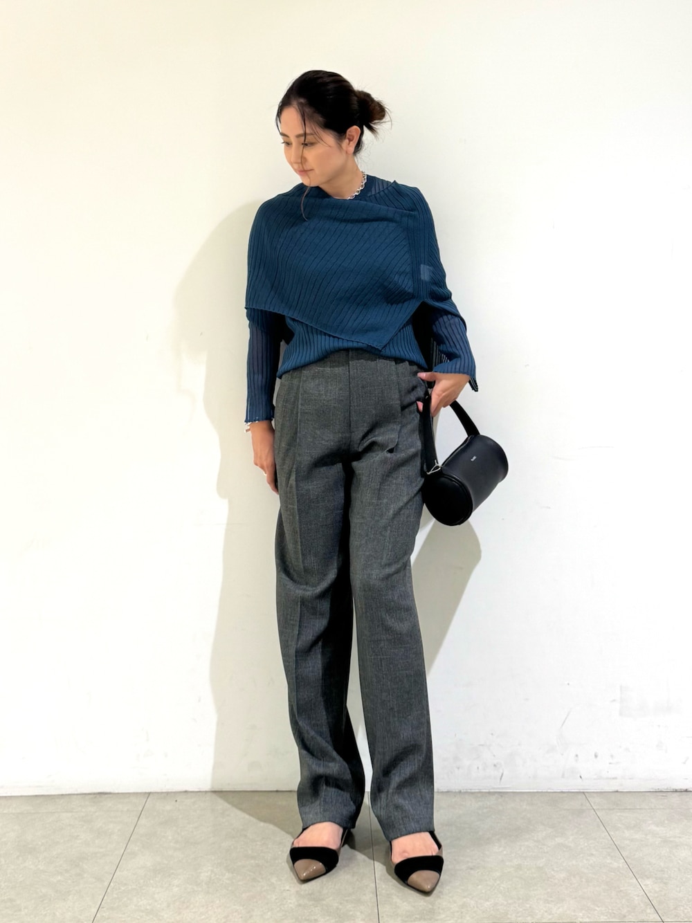 ブルー系のニット/セーター、ブラック系のバッグ、グレー系のその他パンツを着用したレディースの秋コーディネートの1枚目の写真