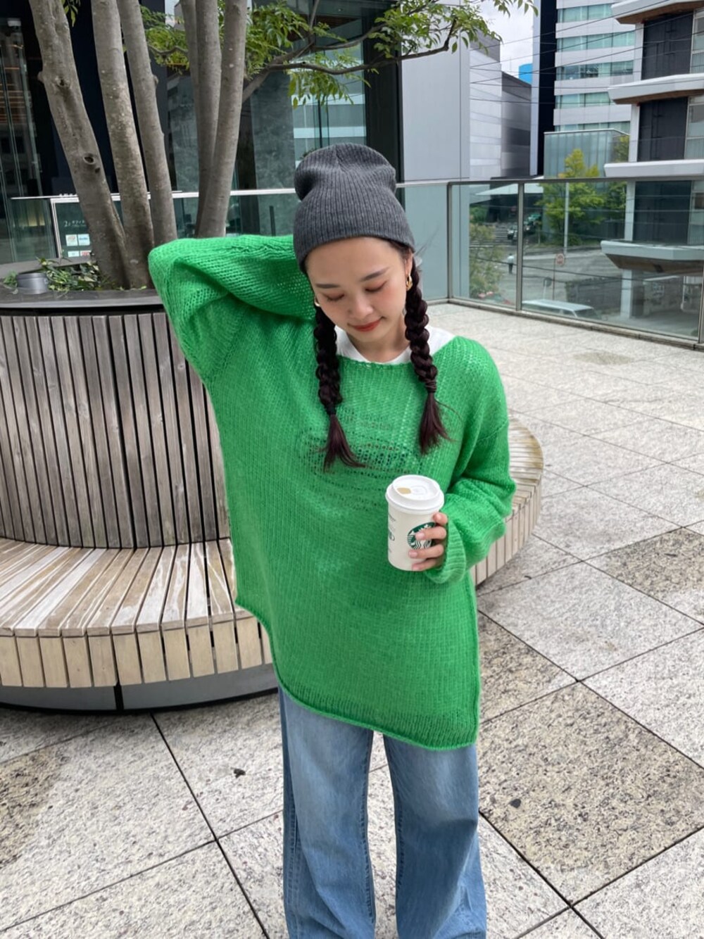 ブルー系のデニムパンツ、ホワイト系のTシャツ/カットソー、グリーン系のニット/セーターを着用したレディースの秋コーディネートの1枚目の写真