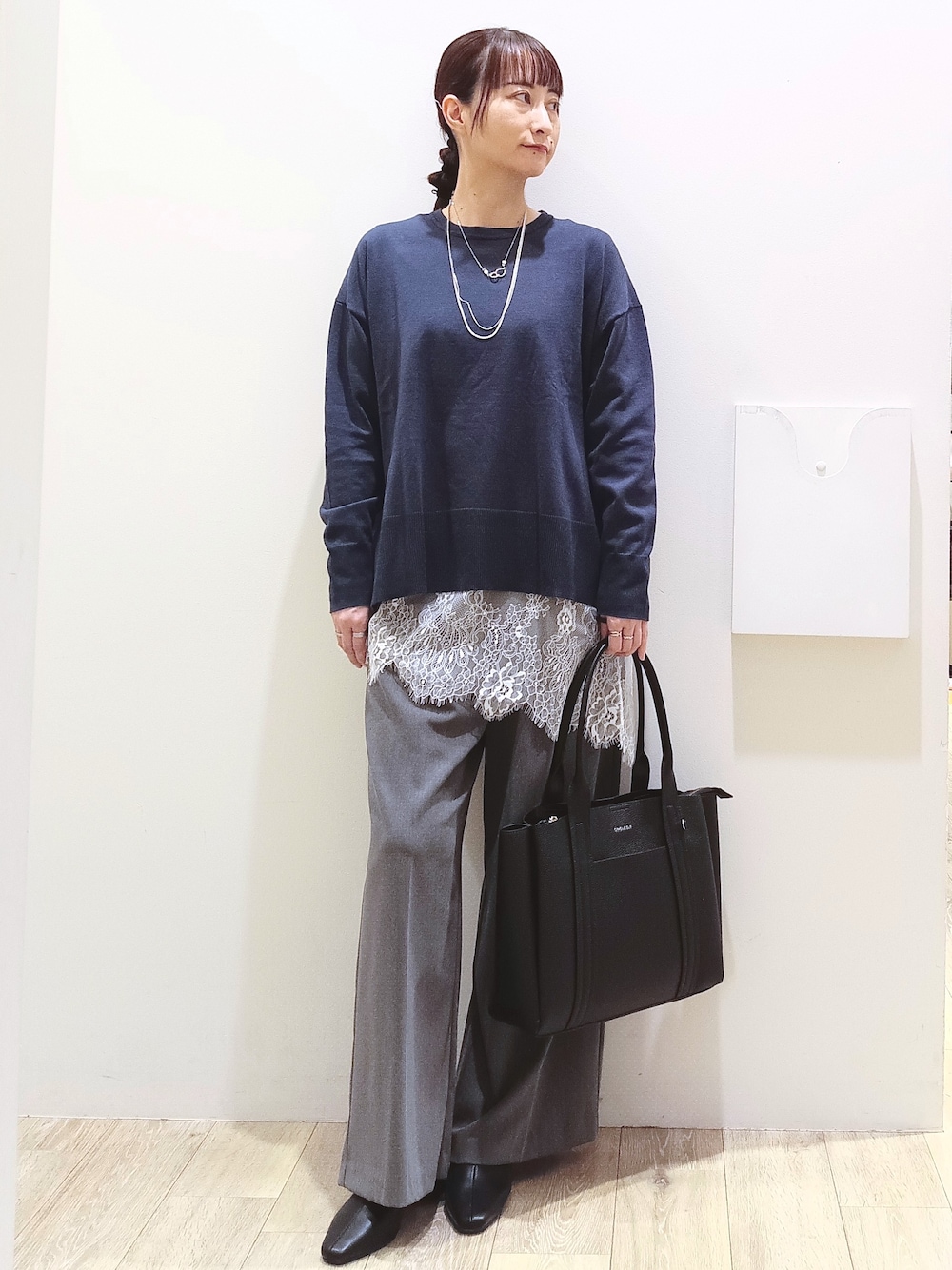 ブルー系のニット/セーター、ホワイト系のTシャツ/カットソー、グレー系のその他パンツを着用したレディースの秋コーディネートの1枚目の写真