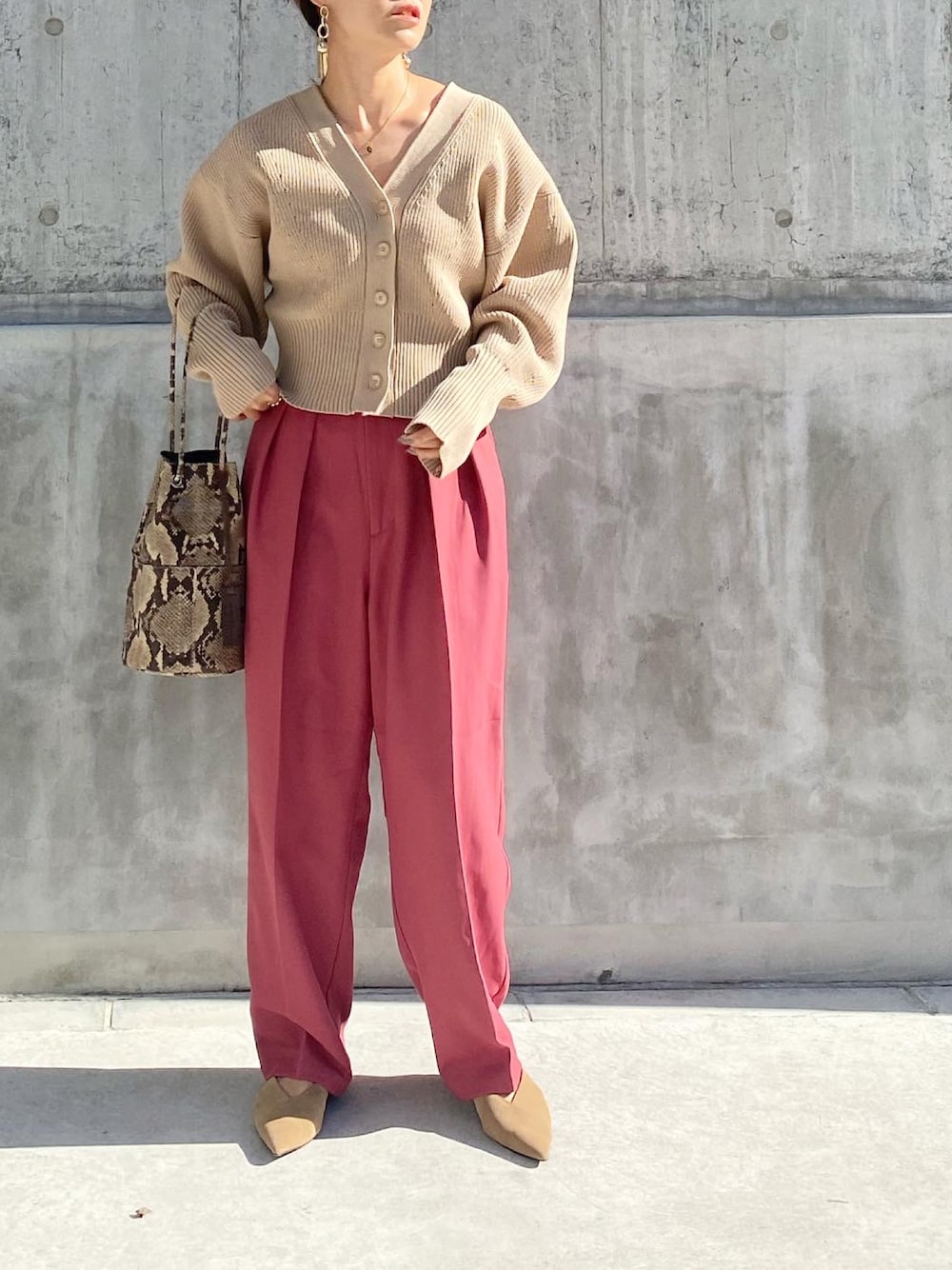 ピンク系のその他パンツ、ベージュ系のカーディガン/ボレロ、その他のハンドバッグを着用したレディースの秋コーディネートの1枚目の写真
