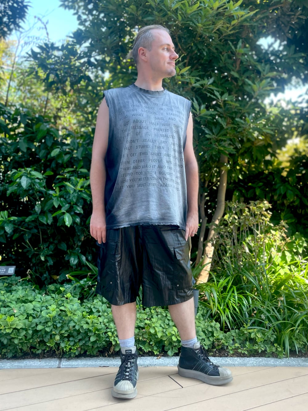 ブラック系のTシャツ/カットソー、ブラック系のカーゴパンツ、ブラック系のスニーカーを着用したメンズの秋コーディネートの1枚目の写真
