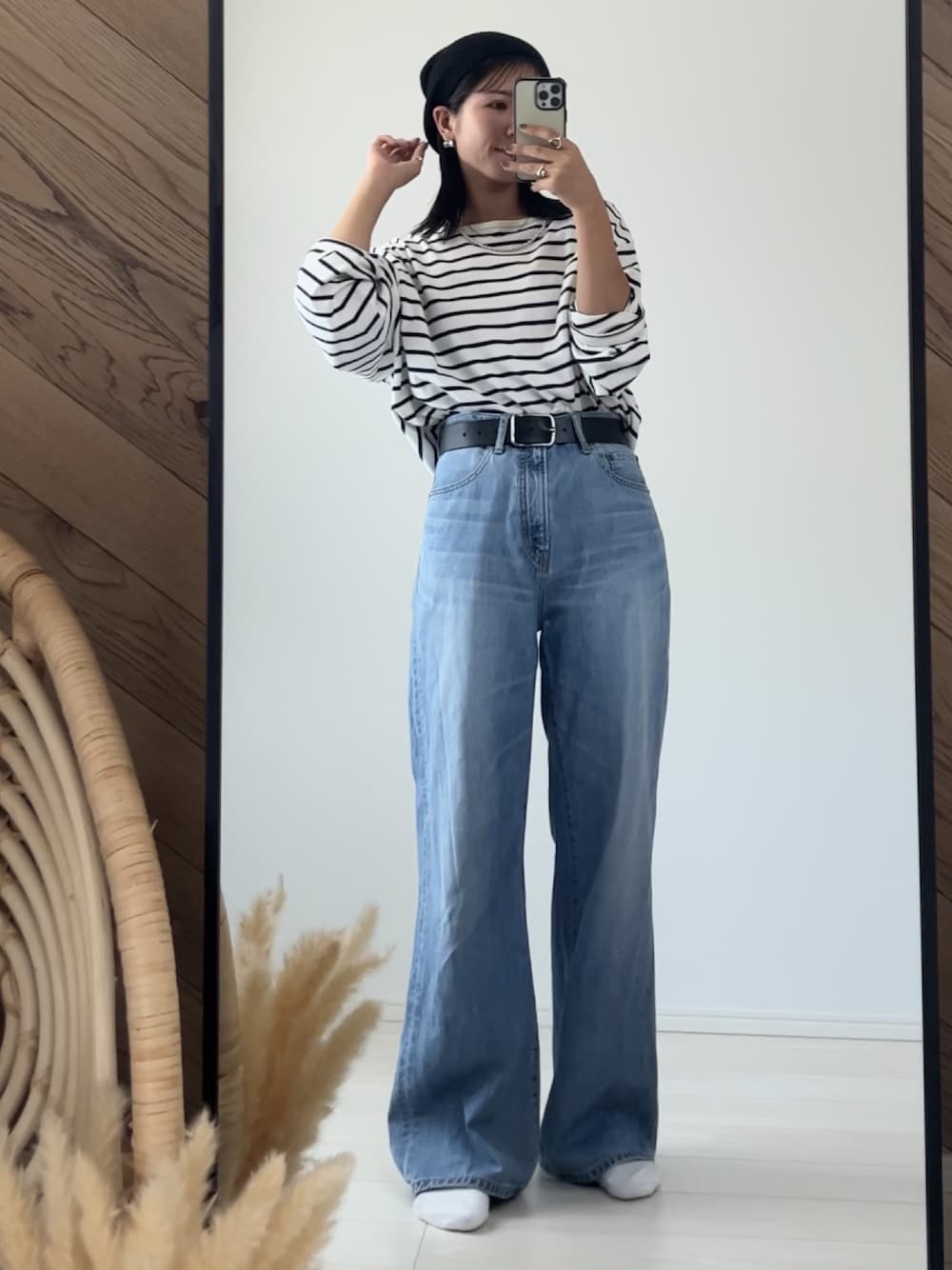 ブルー系のデニムパンツ、ブラック系のベルト、ブラック系のニットキャップ/ビーニーを着用したレディースの秋コーディネートの1枚目の写真