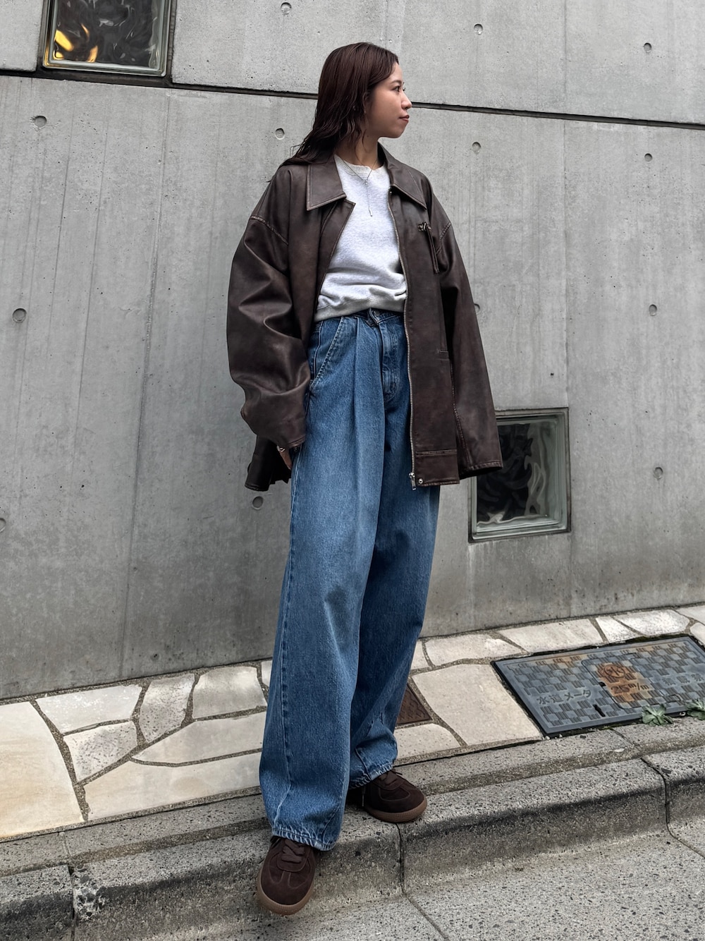 ブルー系のデニムパンツ、グレー系のスウェット、ブラウン系のブルゾンを着用したレディースの秋コーディネートの1枚目の写真