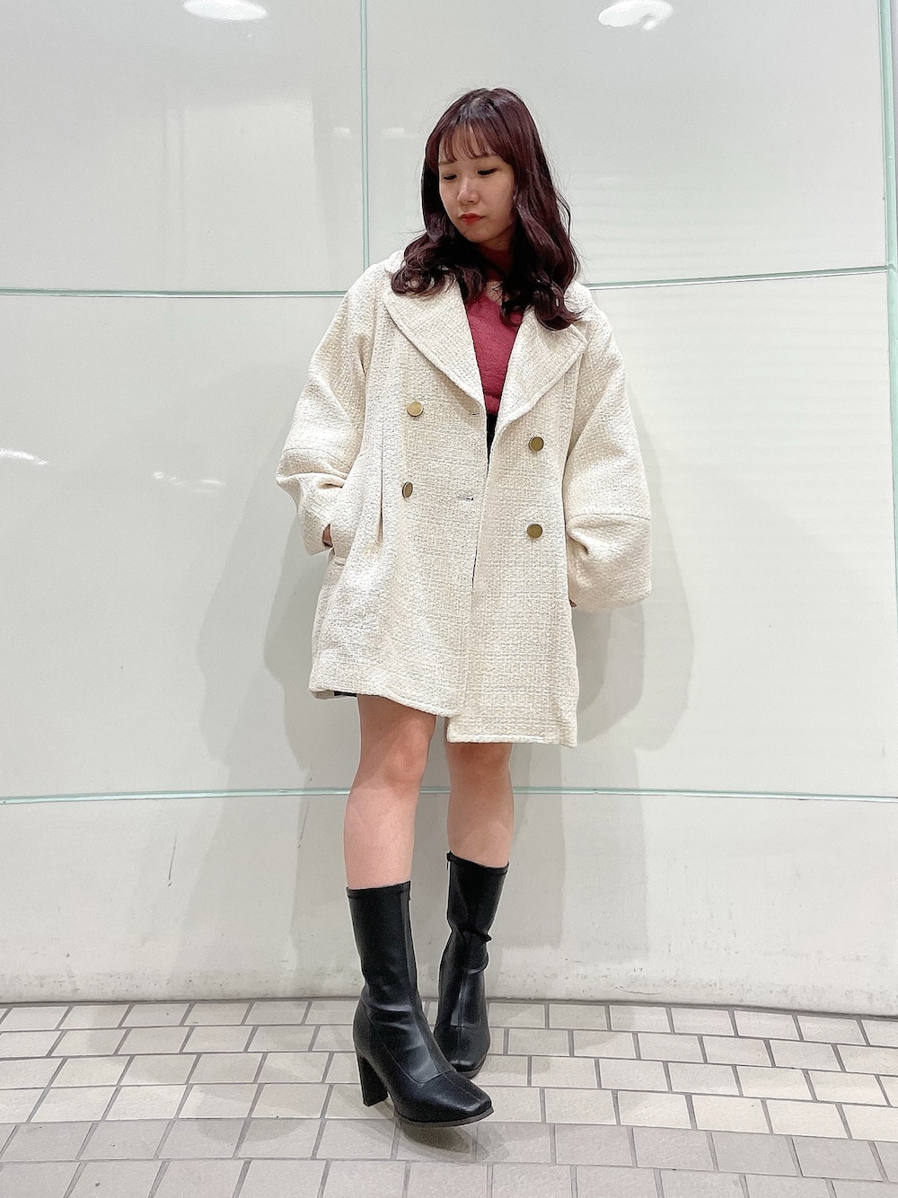 ピンク系のニット/セーター、グレー系のスカート、ホワイト系のその他アウターを着用したレディースの秋コーディネートの1枚目の写真