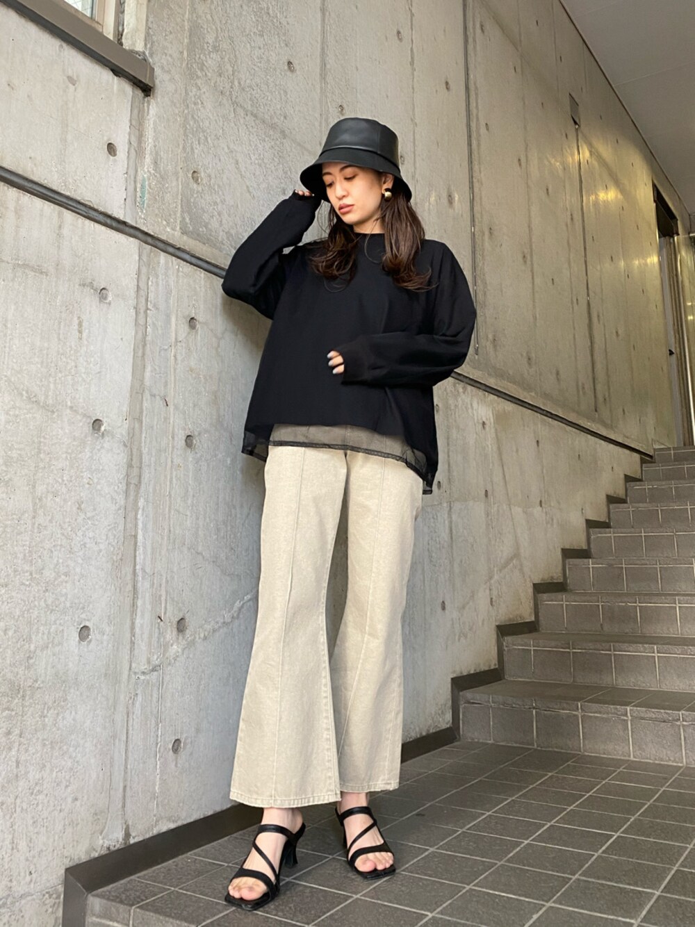 ベージュ系のその他パンツ、ブラック系のサンダル、ブラック系のTシャツ/カットソーを着用したレディースの冬コーディネートの1枚目の写真