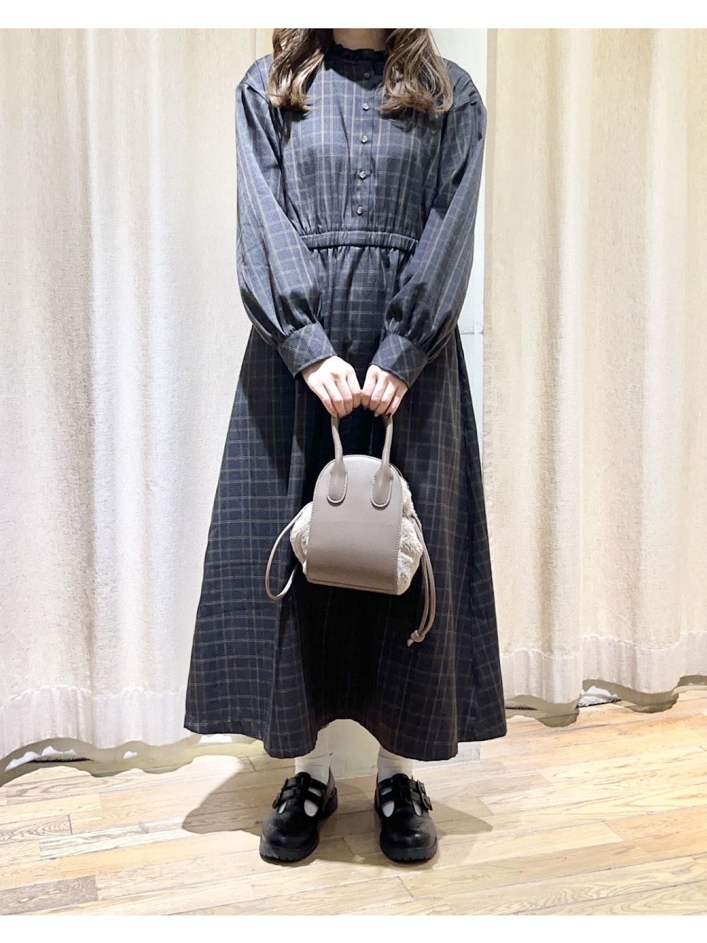 ブラック系のワンピース、ブラック系のその他シューズ、ブラウン系のショルダーバッグを着用したレディースの秋コーディネートの1枚目の写真