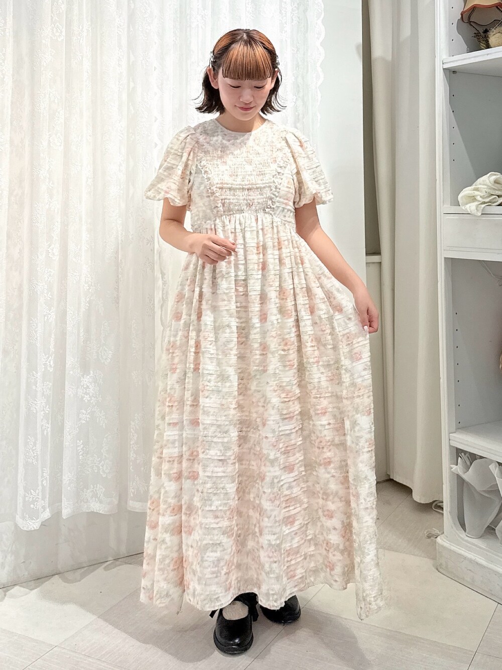 ブラック系のパンプス、ピンク系のワンピースを着用したレディースの夏コーディネートの1枚目の写真