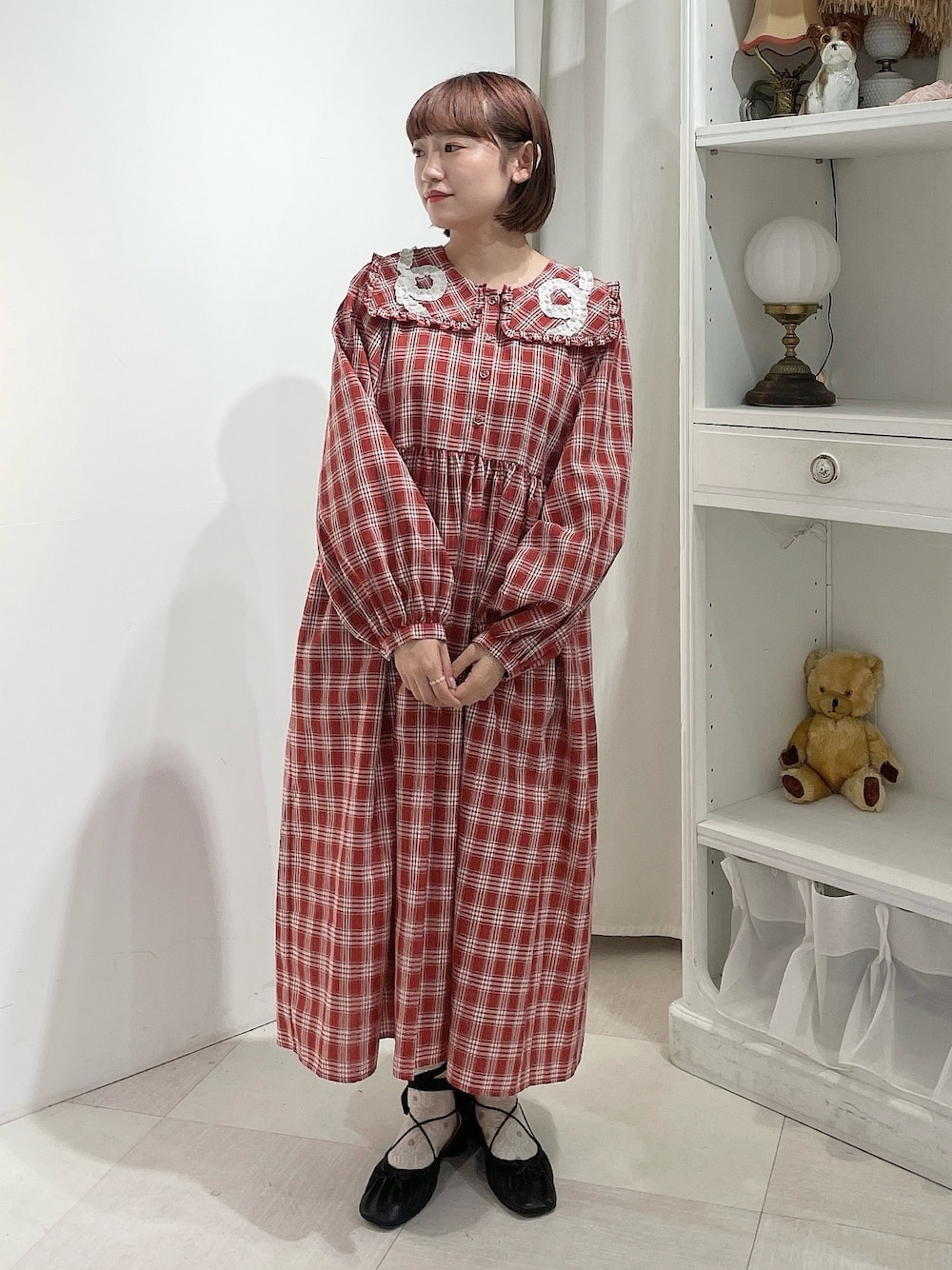 レッド系のワンピース、ブラック系のバレエシューズを着用したレディースの春コーディネートの1枚目の写真