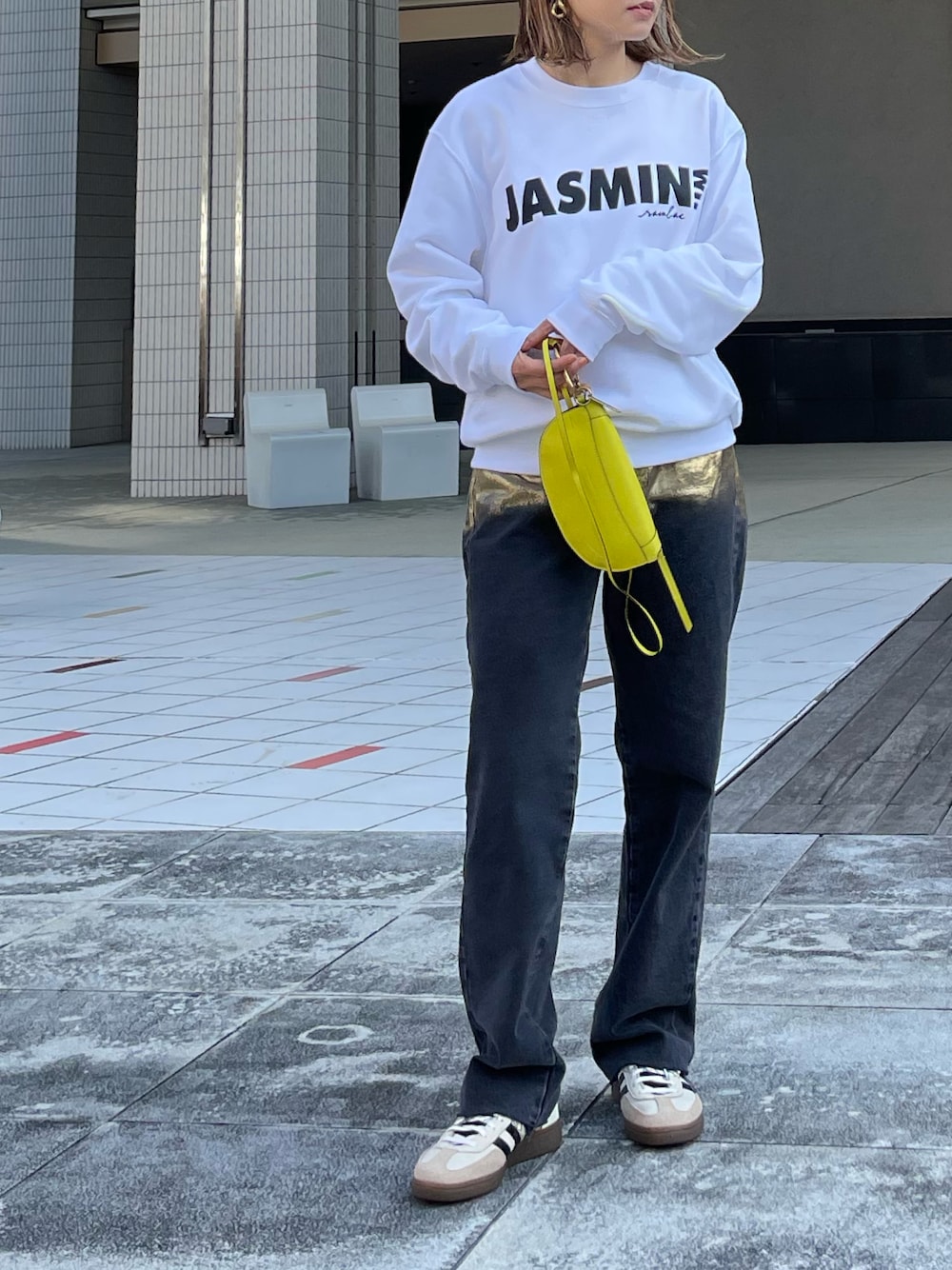 ホワイト系のスウェット、ブラック系のデニムパンツ、ホワイト系のスニーカーを着用したレディースの冬コーディネートの1枚目の写真