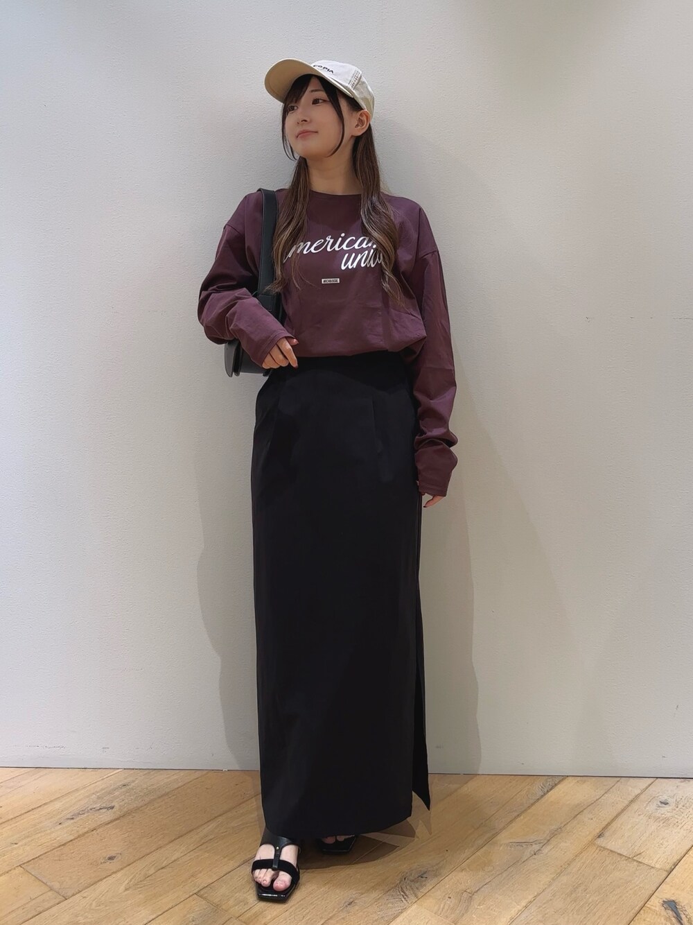 ブラック系のショルダーバッグ、ブラウン系のTシャツ/カットソー、ブラック系のスカートを着用したレディースの夏コーディネートの1枚目の写真