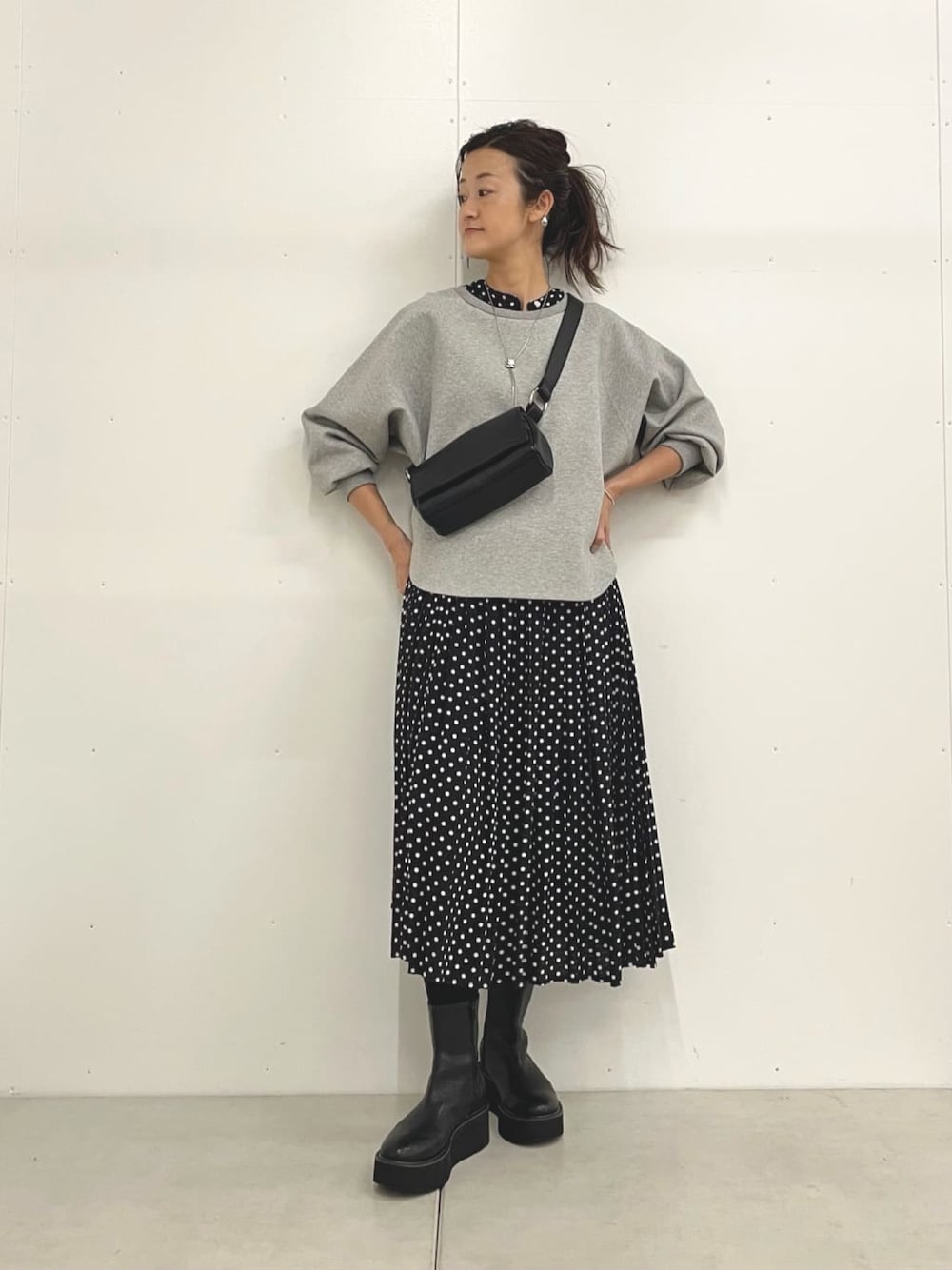 グレー系のTシャツ/カットソー、ブラック系のショルダーバッグ、ブラック系のワンピースを着用したレディースの秋コーディネートの1枚目の写真