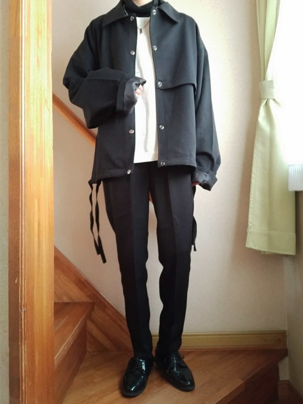 ブラック系のブルゾン、ブラック系のスラックス、シルバー系のネックレスを着用したレディースの秋コーディネートの1枚目の写真