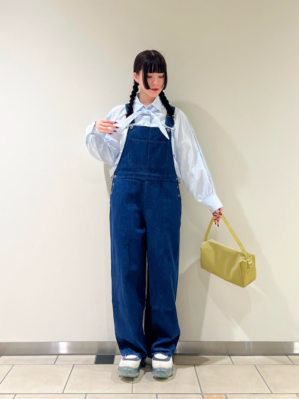 ブルー系のシャツ/ブラウス、ブルー系のサロペット/オーバーオール、イエロー系のトートバッグを着用したレディースの春コーディネートの1枚目の写真