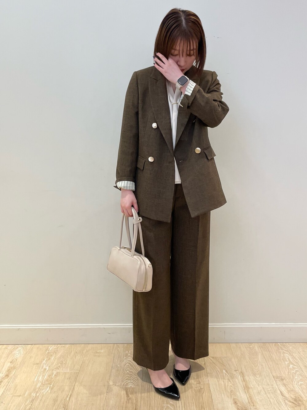 ブラウン系のテーラードジャケット、ブラウン系のその他パンツ、ホワイト系のシャツ/ブラウスを着用したレディースの夏コーディネートの1枚目の写真